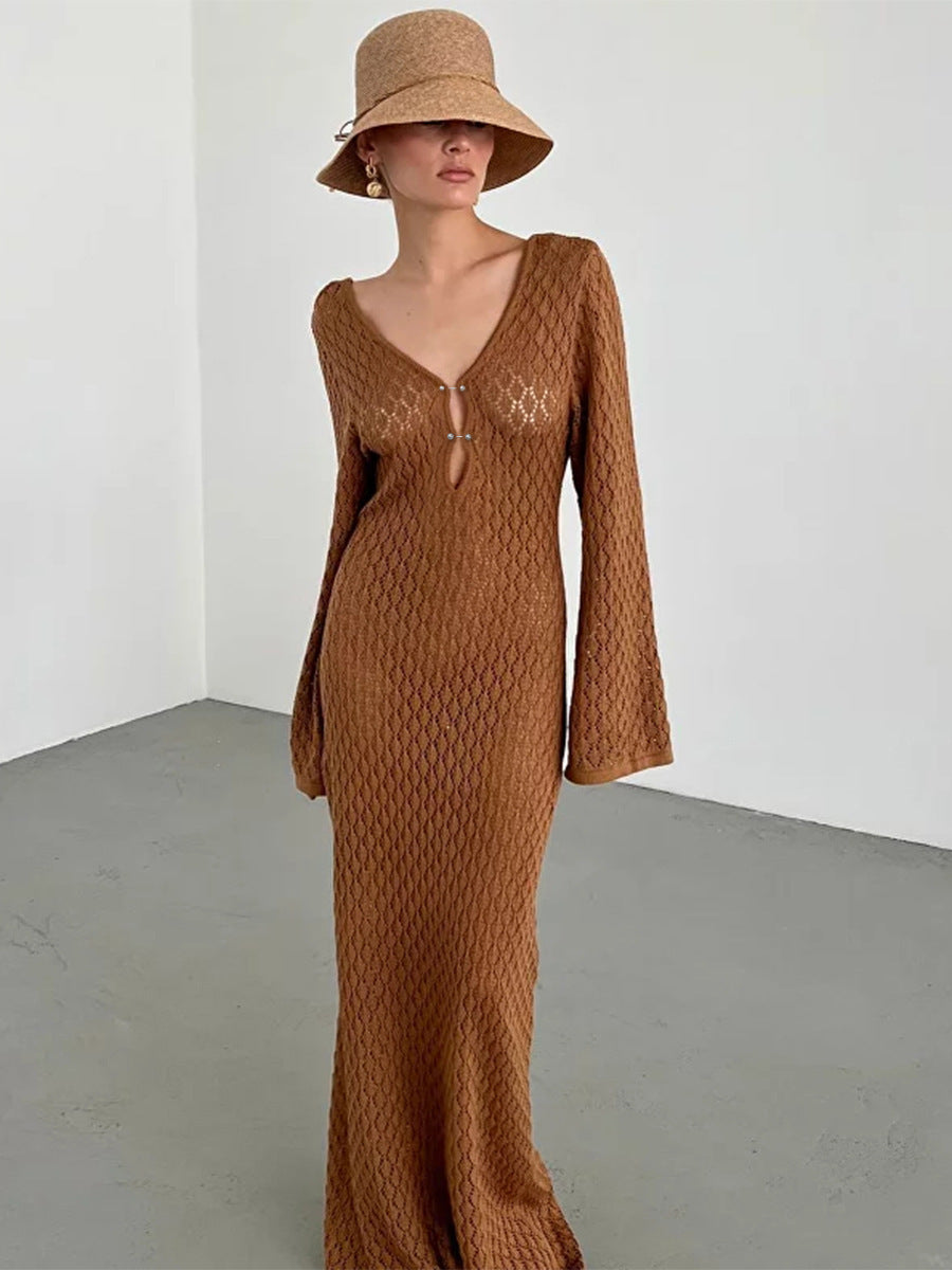 Woman wearing a long brown crochet knit dress with long sleeves.