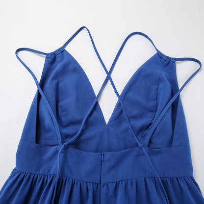 Close-up of the back of a blue maxi dress with thin straps on a white background