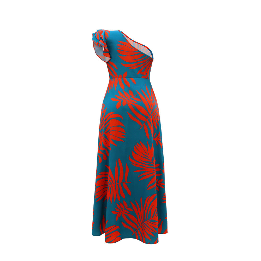 Teal dress with red tropical leaf pattern on a white background