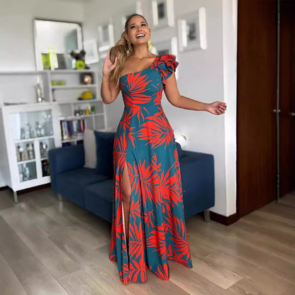 Woman in a red and teal floral dress standing in a living room.